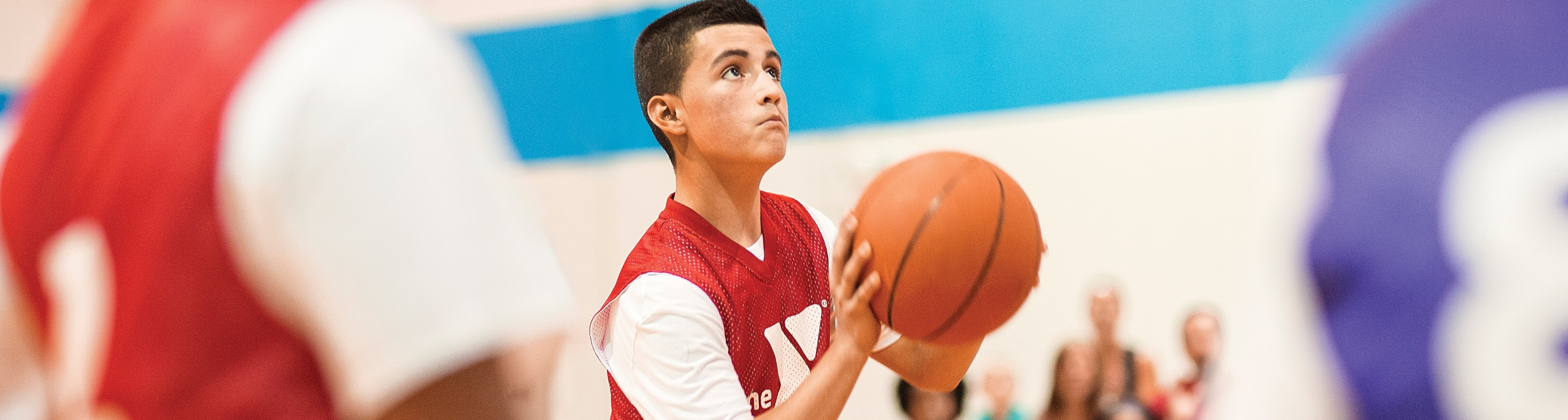 Boy with basketball getting ready to shoot the ball.