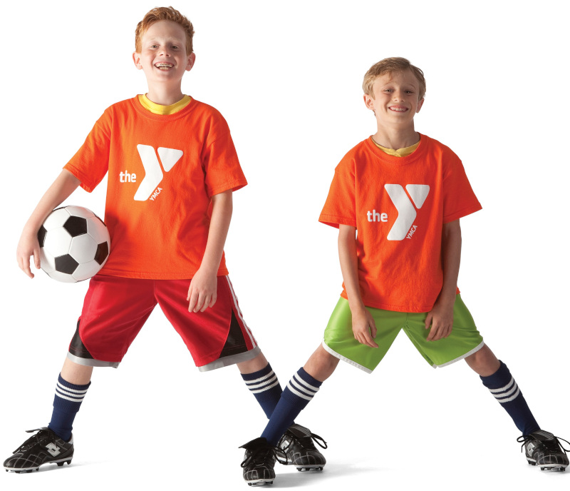 Two boys posing with a soccer ball.