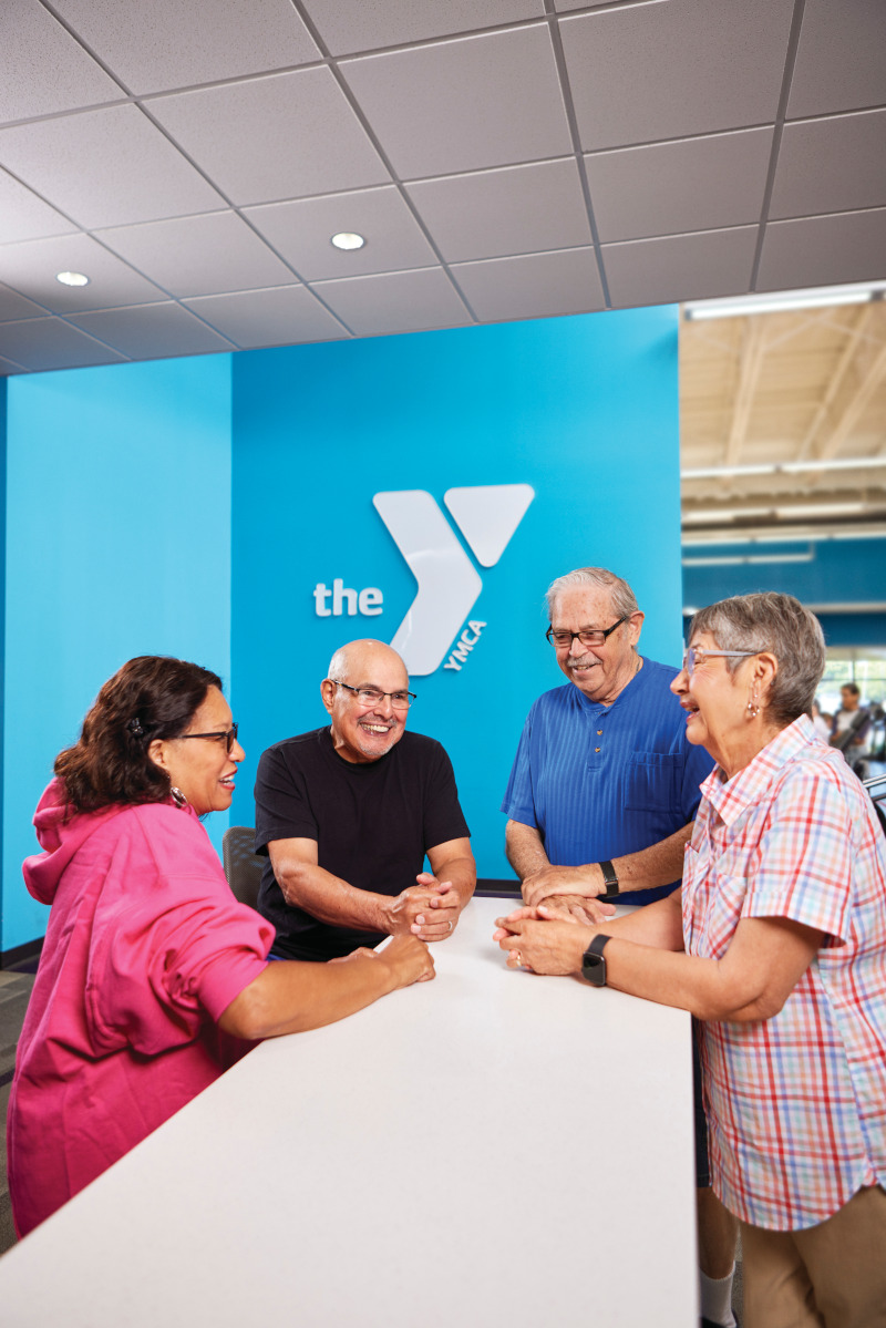 YMCA members having a conversation around a table.