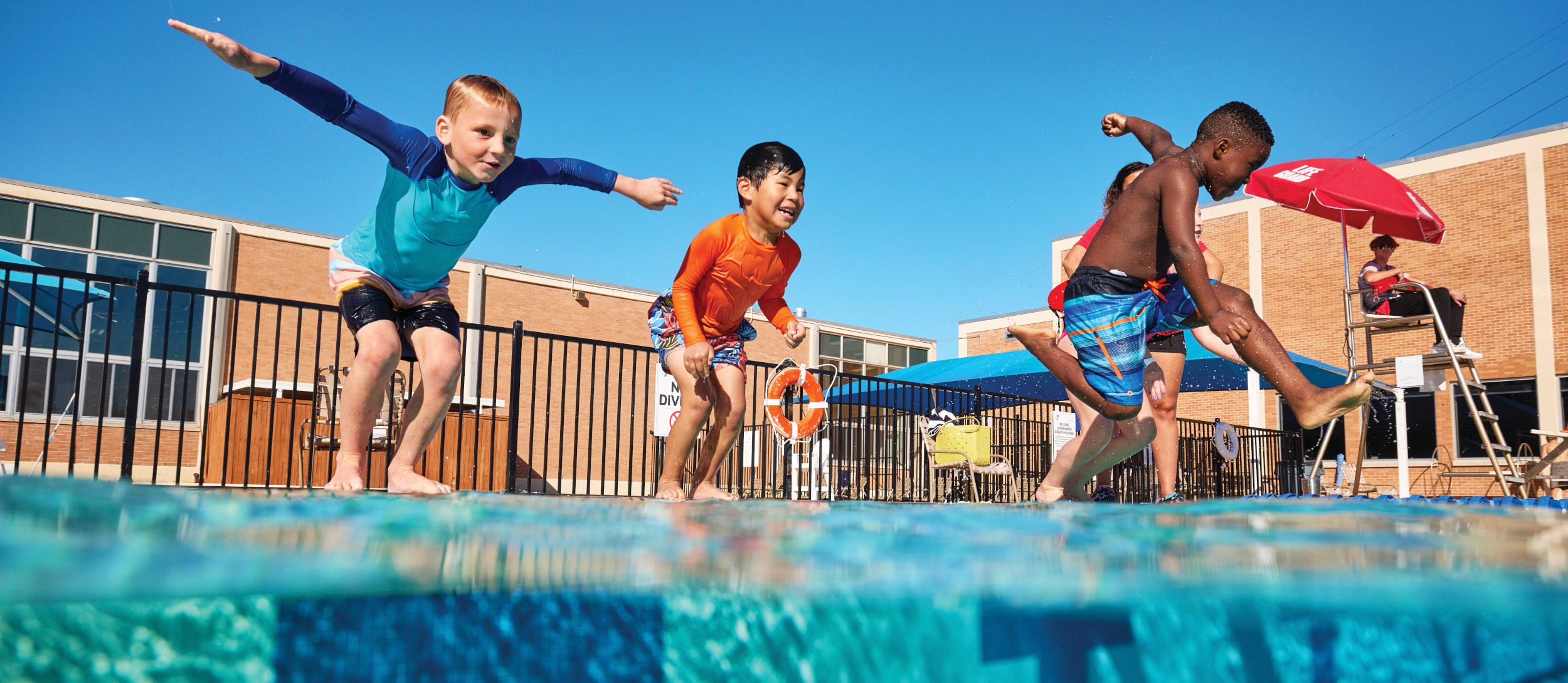 Children swimming in outdoor pool.